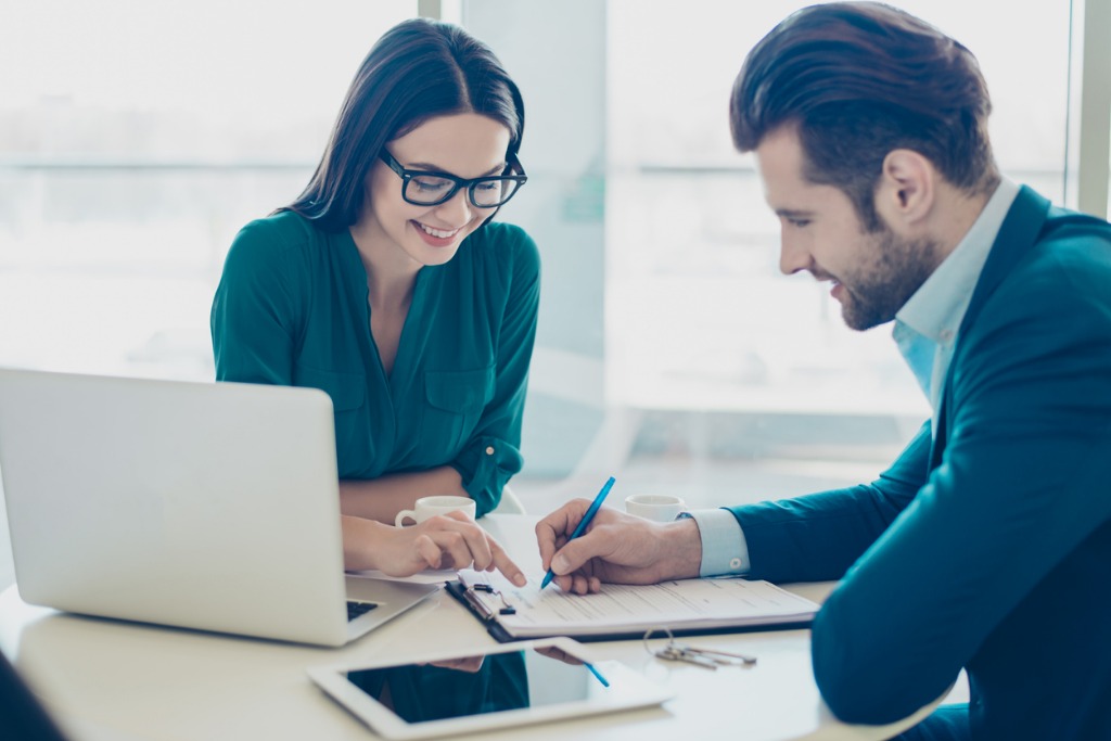 broker and client at signing